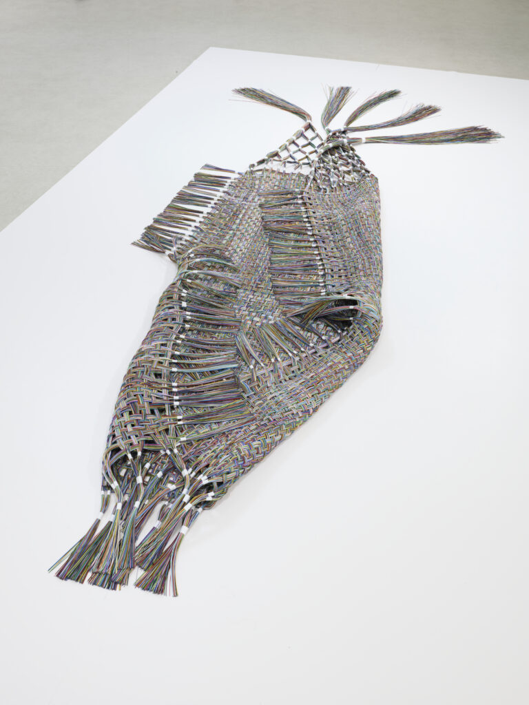tissage de 350 cm en fibres optiques colorées, posé au sol et légèrement plié sur lui-même, vers l'intérieur.